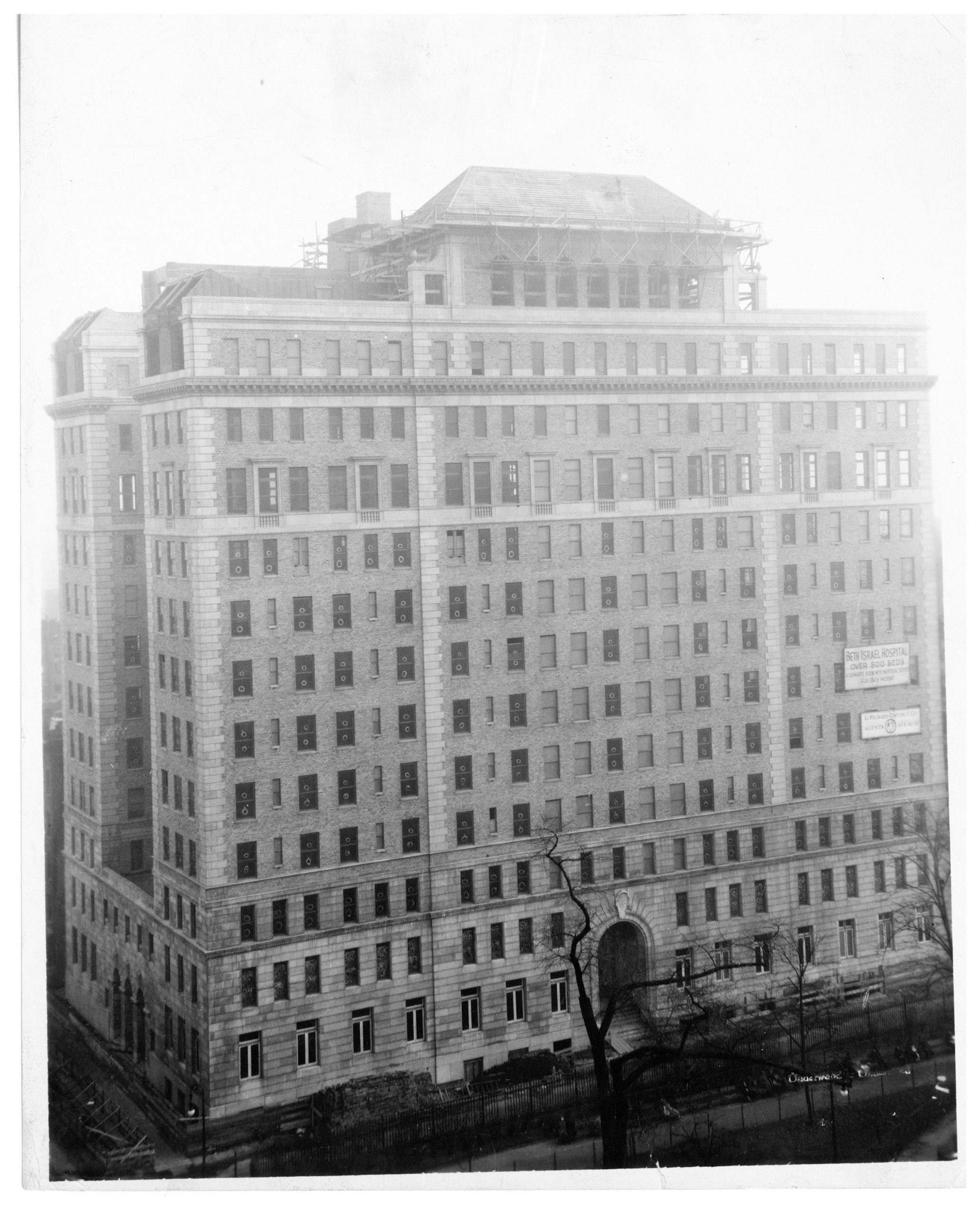 Black-and-white photograph of Dazian Pavillion including sign that says "Beth Israel Hospital: Over 500 beds, a separate room with individual service for each patient"