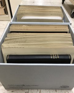 Two record cartons filled with folders of archival material including bound volumes.